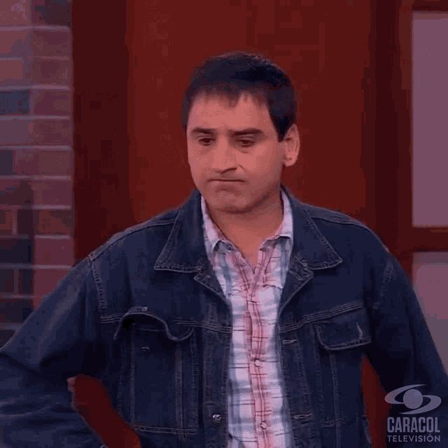 a man in a denim jacket with the word nada on his chest