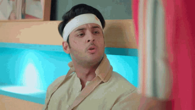 a man with a bandage on his head is looking at a book