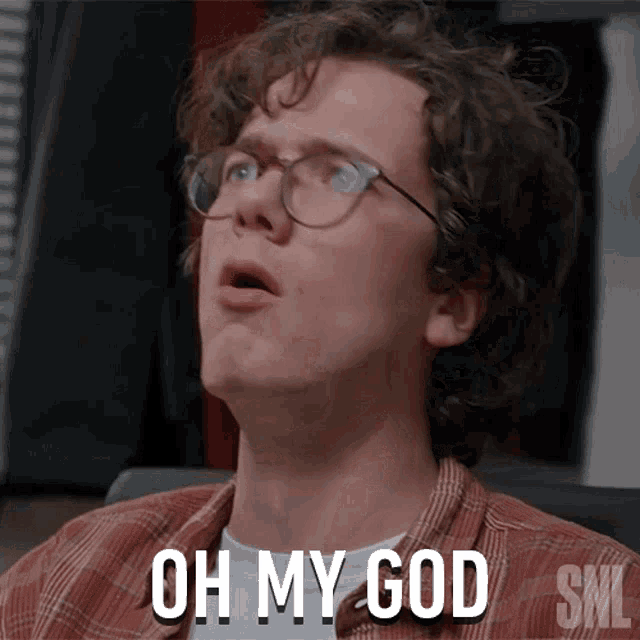 a man with glasses and a plaid shirt says " oh my god "