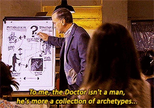 a man stands in front of a white board with a question mark on it and says to me the doctor isn 't a man