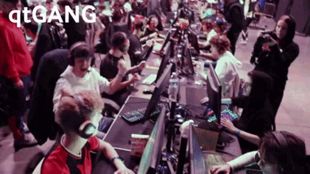 a group of people playing a video game with the word qtgang on the bottom