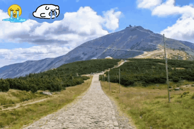 a cartoon drawing of a mountain with a crying face and a cloud