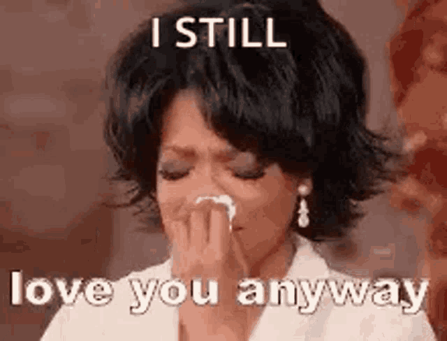 a woman is crying and holding a napkin in her hand .