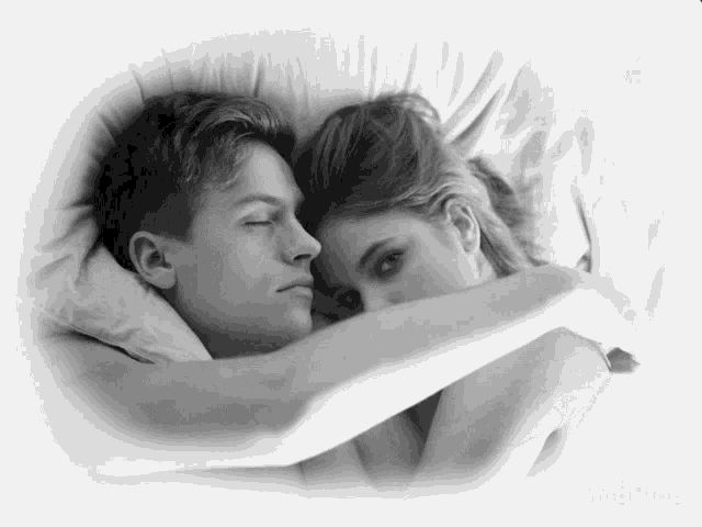 a black and white photo of a man and a woman hugging each other