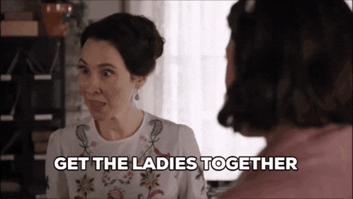 a woman talking to another woman with the words get the ladies together above her