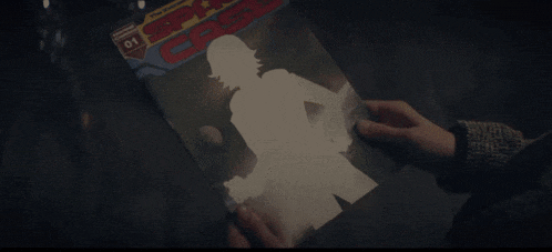 a person is holding a copy of a comic book called spy case