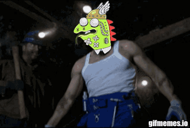a man in a white tank top and blue pants has a cartoon face on his head and the words gifmemes.io below him