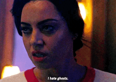 a close up of a woman 's face with a caption that says `` i hate ghosts . ''