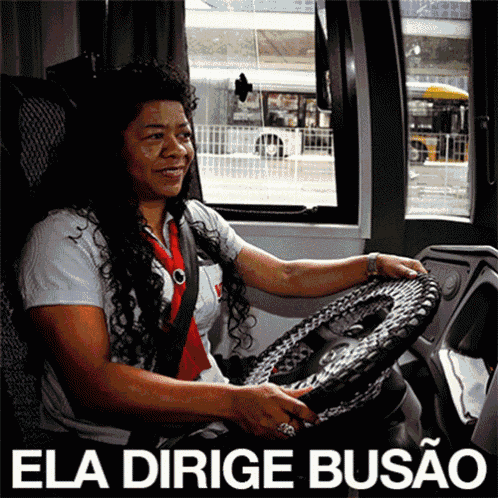 a woman driving a bus with the words " ela dirigie busao " on the bottom right