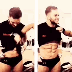 a man in underwear is taking off his shirt and showing his abs .