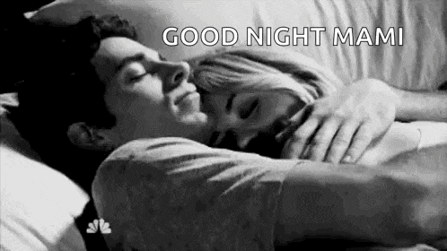 a man and a woman are sleeping in a bed together .