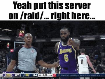 a basketball player in a purple lakers jersey stands next to a referee