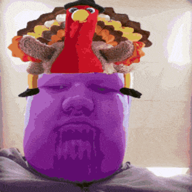 a purple man with a stuffed turkey on top of his head