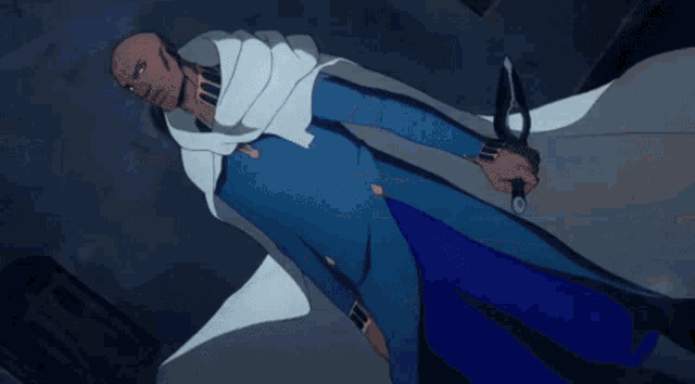 a man in a blue suit is holding a sword in his hand .