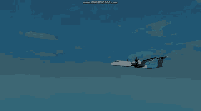 a blue and white airplane is flying through a blue sky with the words www.bandicam.com on the bottom right