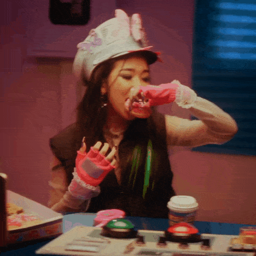 a woman wearing a hat with a butterfly on it is eating something