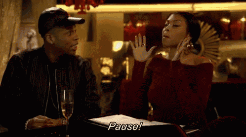 a man and a woman are sitting at a table with a glass of champagne and the woman is saying pause .