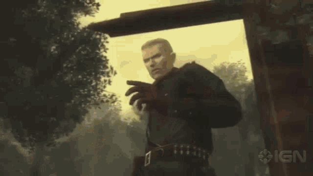 a man in a military uniform is holding his finger to his mouth and the word ign is on the bottom right