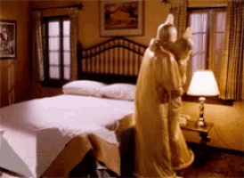 a bedroom with a bed and a lamp and a statue