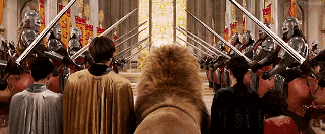 a lion stands in front of a crowd of knights with swords