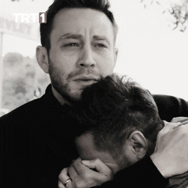 a man hugging another man with trt 1 written on the bottom