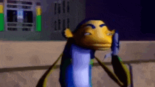 a cartoon character is standing in front of a building talking on a cell phone .