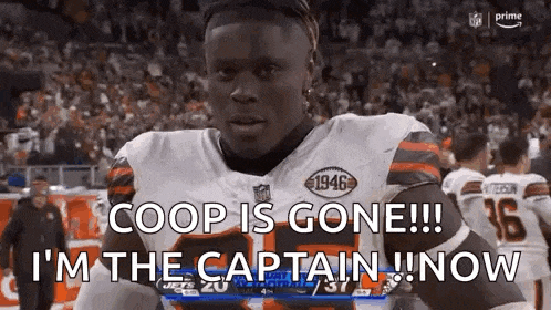 a football player is standing on a field with the words `` coop is gone ! ''