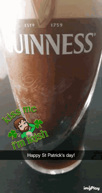a glass of guinness beer with a sticker that says kiss me i 'm irish and happy st patrick 's day
