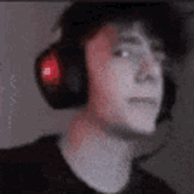 a close up of a person wearing headphones with a red light on them .
