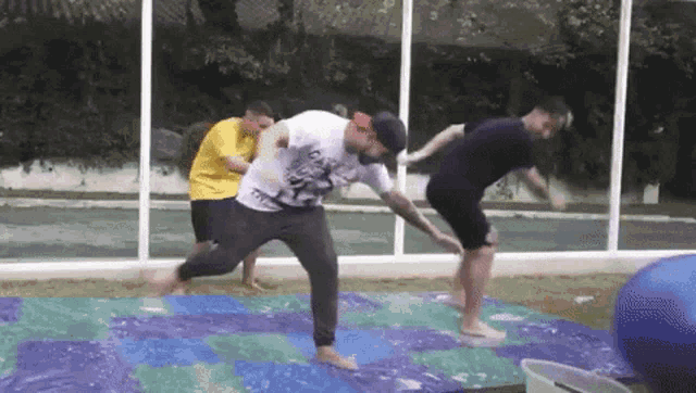 a group of men are playing a game of twister outside