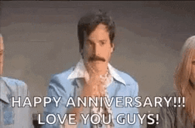 a man with a mustache is holding his hands together and saying `` happy anniversary ! love you guys ! '' .