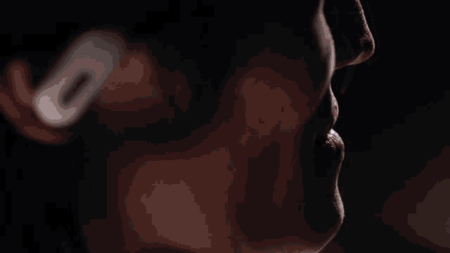 a close up of a person 's face with a white ear bud in their ear