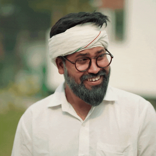 a man with a beard and glasses wearing a headband