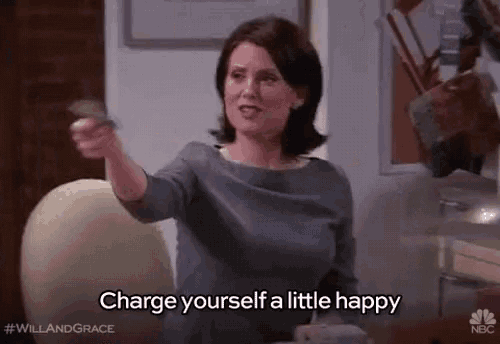 a woman is holding a piece of paper and saying `` charge yourself a little happy '' while sitting in a chair .
