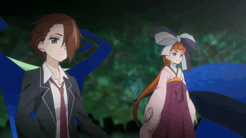 a man in a suit and tie and a woman in a kimono are standing next to each other