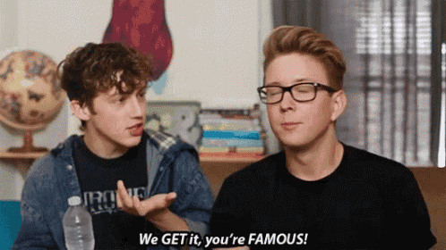 two young men are talking to each other and one of them is saying we get it you 're famous