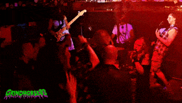 a group of people playing instruments in front of a sign that says grindhorror