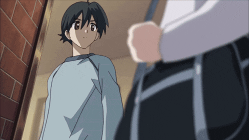 a boy in a blue shirt is standing next to another boy in black pants
