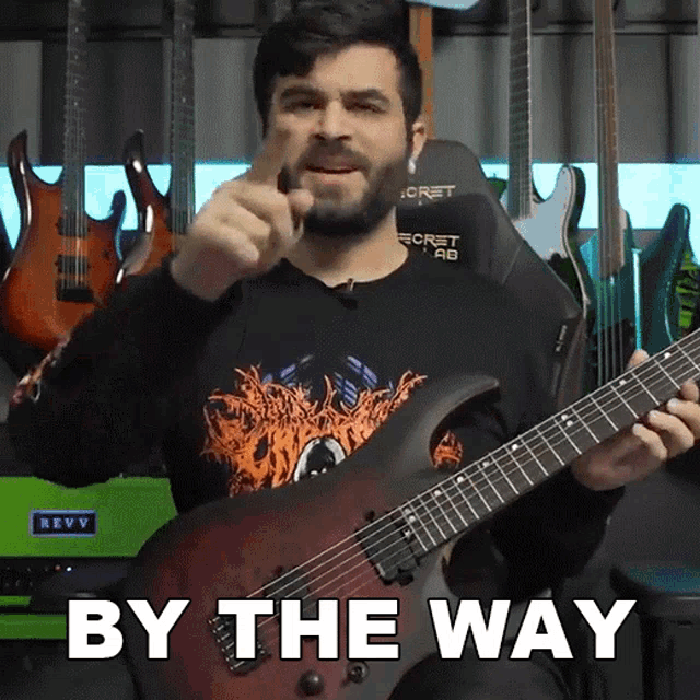 a man holding a guitar with the words by the way on the bottom