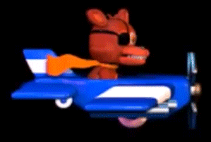 a stuffed animal is flying in a blue toy airplane .