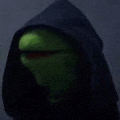 kermit the frog is wearing a black hood and a red mouth .