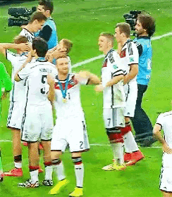 a group of soccer players on a field one of whom has the number 5 on his shirt