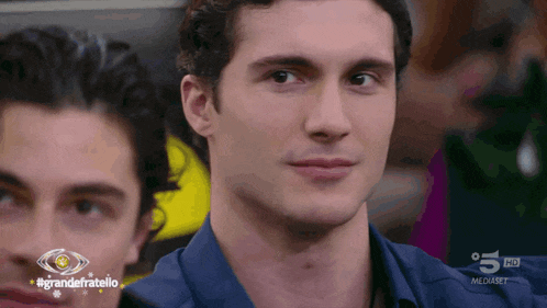 a close up of a man 's face with the words grandefratello in the corner