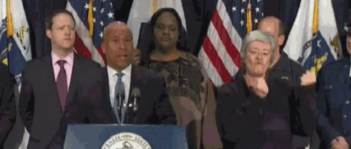 a group of people standing in front of a podium that says ' massachusetts state ' on it