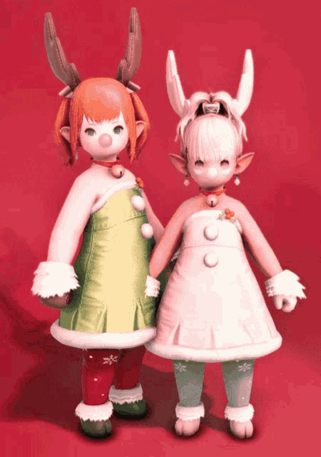 two dolls are standing next to each other and one has antlers on