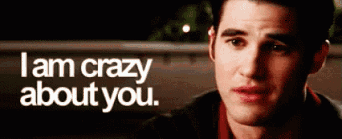 a close up of a man 's face with a caption that says `` i am crazy about you '' .