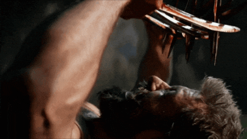 a close up of a man 's face with a pair of claws on it