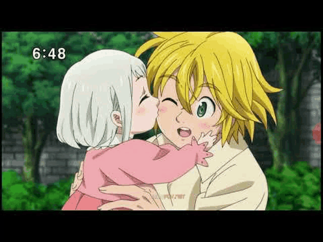 a man and a little girl are kissing each other in a park .