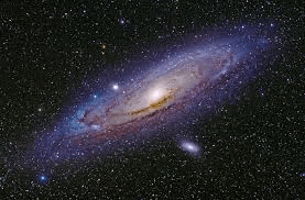 a spiral galaxy in the middle of a galaxy in the night sky .