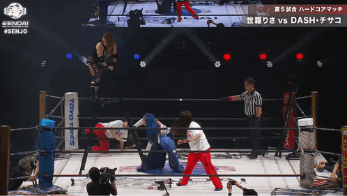 two women wrestling in a ring with the words toyo tires on the corner